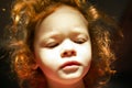 Red-haired little girl with a doll face with hard sun light and luminous hair.  cute fairy baby Royalty Free Stock Photo