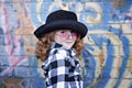 Red haired little girl in front of brick wall Royalty Free Stock Photo