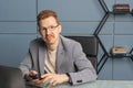 red-haired man with glasses in the office