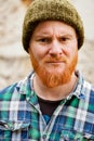 Red haired man with plaid shirt looking at camera Royalty Free Stock Photo