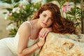 The red-haired sensual girl with freckles on a background of yellow rocks at sunset in summer Royalty Free Stock Photo