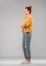 Red haired teenage girl in shirt and torn jeans Royalty Free Stock Photo