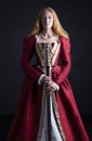 Red-haired Tudor woman in red dress Royalty Free Stock Photo