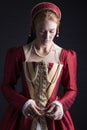 Red-haired Tudor woman in red dress Royalty Free Stock Photo
