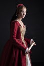 Red-haired Tudor woman in red dress Royalty Free Stock Photo