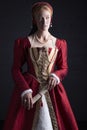 Red-haired Tudor woman in red dress Royalty Free Stock Photo