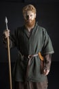 Red-haired Viking posing with weapons