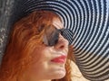 Woman in a black wide-brimmed hat and sunglasses portrait Royalty Free Stock Photo