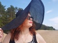 Woman in a black wide-brimmed hat and sunglasses portrait Royalty Free Stock Photo