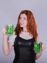 Red haired woman with a glass of green beer. St. Patrick`s Day. Royalty Free Stock Photo