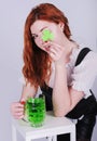 Red haired woman with a glass of green beer. St. Patrick`s Day. Royalty Free Stock Photo