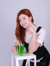 Red haired woman with a glass of green beer. St. Patrick`s Day. Royalty Free Stock Photo