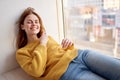 red-haired woman lies near the window dreamy look Royalty Free Stock Photo