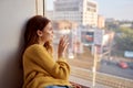 red-haired woman lies near the window dreamy look Royalty Free Stock Photo