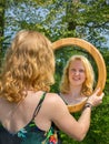 Red-haired woman looking at her mirror reflection Royalty Free Stock Photo
