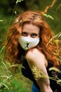 Red-haired woman in a mask with a cat`s face Royalty Free Stock Photo