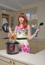 Red haired woman with new multicooker and small dog