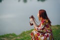 red-haired woman outdoors binoculars in hands leisure travel walk