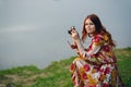 red-haired woman outdoors binoculars in hands leisure travel walk