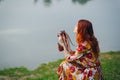 red-haired woman outdoors binoculars in hands leisure travel walk