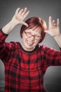 Red-haired woman, portrait, messing around, sticking out the ton Royalty Free Stock Photo