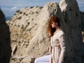 Red-haired woman posing rocks nature rest Royalty Free Stock Photo