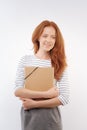 Red-haired woman pressing folder to the chest Royalty Free Stock Photo