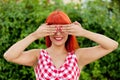 Red haired woman covering her eyes Royalty Free Stock Photo