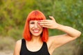 Red haired woman covering her eyes in a park Royalty Free Stock Photo