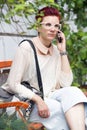 Red-haired woman talking on the phone Royalty Free Stock Photo