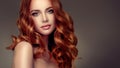 Red haired woman with voluminous, shiny and curly hairstyle.Flying hair. Royalty Free Stock Photo