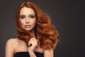 Red haired woman with voluminous, shiny and curly hairstyle. Frizzy hair. Royalty Free Stock Photo
