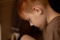 Red-haired young boy in thought, attention Royalty Free Stock Photo