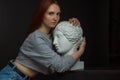 Red-haired young girl on black background in a gray T-shirt Royalty Free Stock Photo