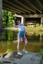 Red haired young girl wrapped in orange blanket posing near the swamp or lake with duckweed Royalty Free Stock Photo