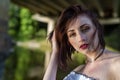 Red haired young girl wrapped in orange blanket posing near the swamp or lake with duckweed Royalty Free Stock Photo