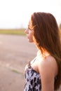 Red-haired young lady in floral dress at sunset Royalty Free Stock Photo