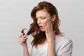 Red-Haired Young Woman Looking At Damaged Hair Over Gray Background Royalty Free Stock Photo