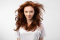 Red-Haired Young Woman With Loose Hair Posing Over White Background Royalty Free Stock Photo