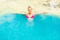 Young woman relaxes in emerald blue lake, Erawan National park, Thailand Royalty Free Stock Photo