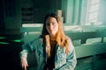 The red-haired young woman sitting in the church pews appears lost in thought. The scene suggests themes of faith and Royalty Free Stock Photo