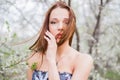 Red-haired young woman in spring orchard Royalty Free Stock Photo