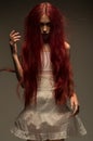 Red haired zombie woman in white cotton dress