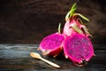 Red half dragon fruit on wooden background Royalty Free Stock Photo