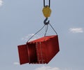 Red half opened door cargo container hang by crane hook accident