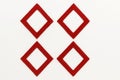 Red hand painted square frames arranged in a two by two grid rotated to diamond orientation with equal spacing on white Royalty Free Stock Photo