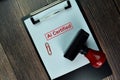 Red Handle Rubber Stamper and Ai Certified text isolated on the table