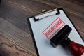 Red Handle Rubber Stamper and Furloughed text isolated on the table