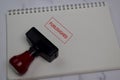 Red Handle Rubber Stamper and Furloughed text isolated on the table