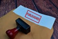 Red Handle Rubber Stamper and Furloughed text Isolated on wooden table background